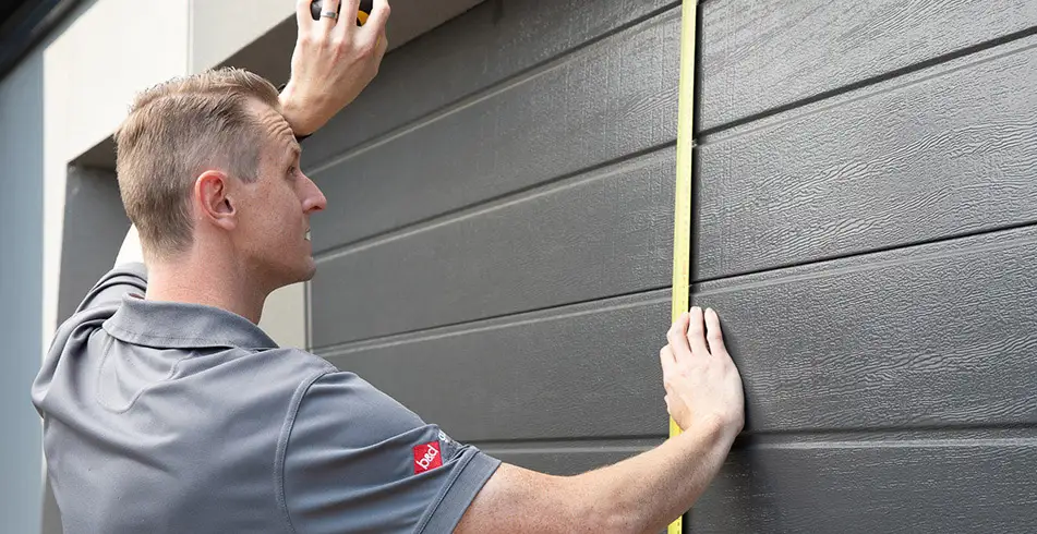 Reliable as Can B&D Technician Measuring Garage Door