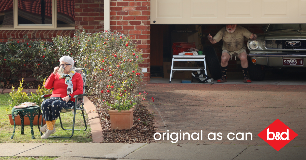 Original as Can B&D old women sitting in front lawn drinking tea, husband in garage, garage door closing