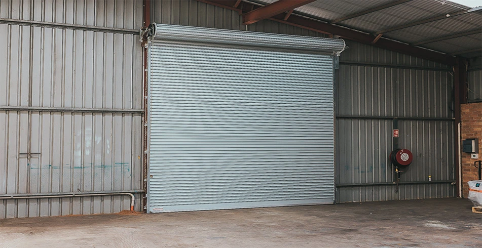 Safe as Can B&D Angled view of Series 2 commercial Roll-A-Door installed in warehouse Home