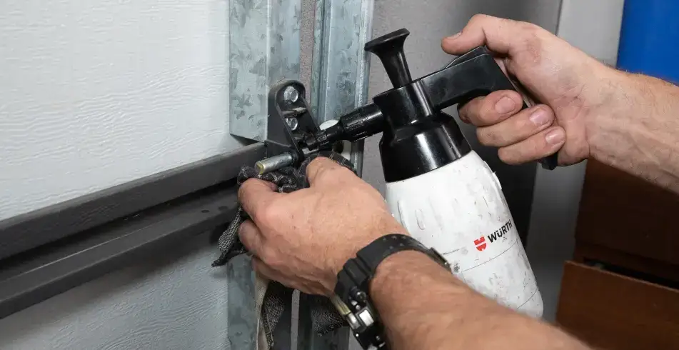Reliable as Can B&D Hands of Someone Lubricating Garage Door Tracks