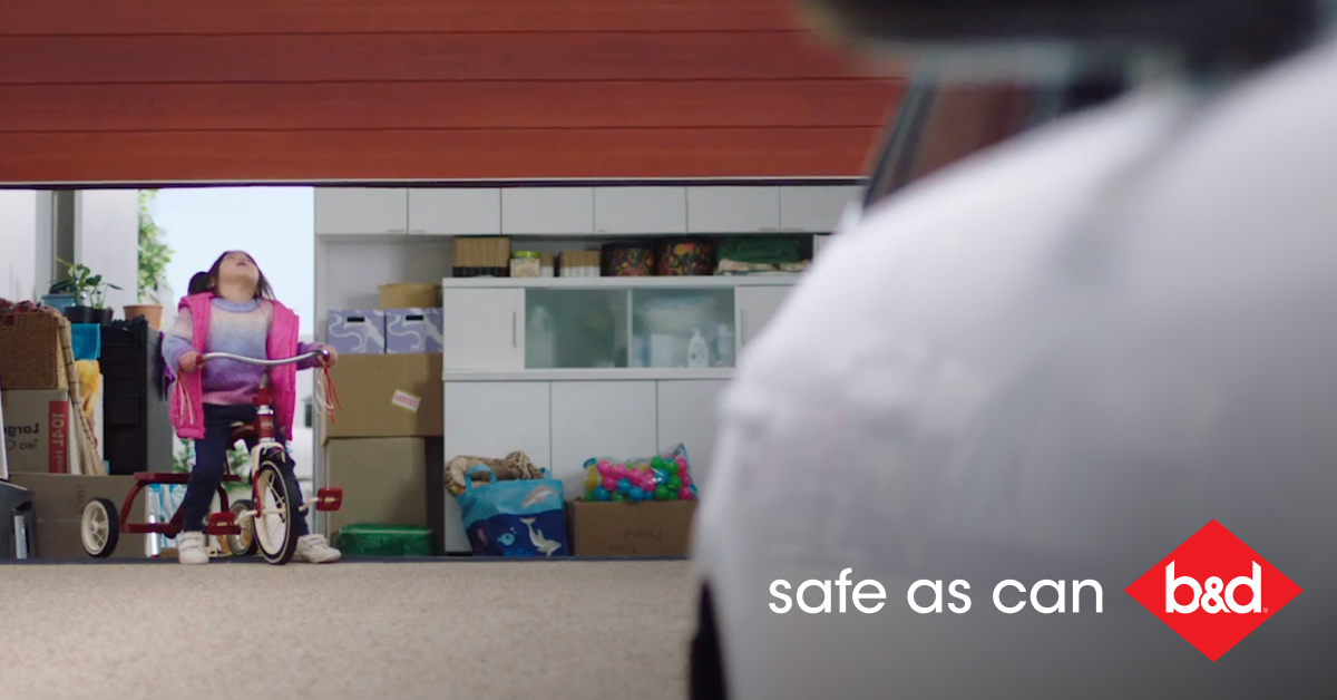 Safe as Can B&D little girl cycling towards closing garage door