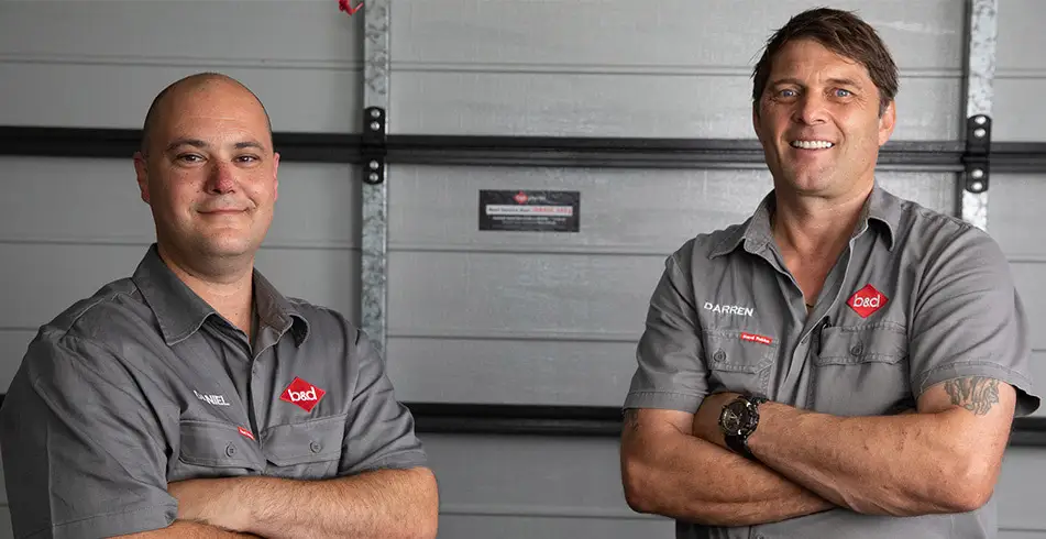 Reliable as Can B&D Two Garage Door Technicians Smiling at the Camera