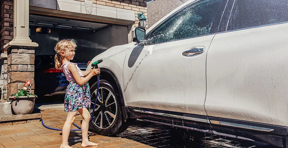 Safe as Can B&D Young Girl Spraying Car with Water